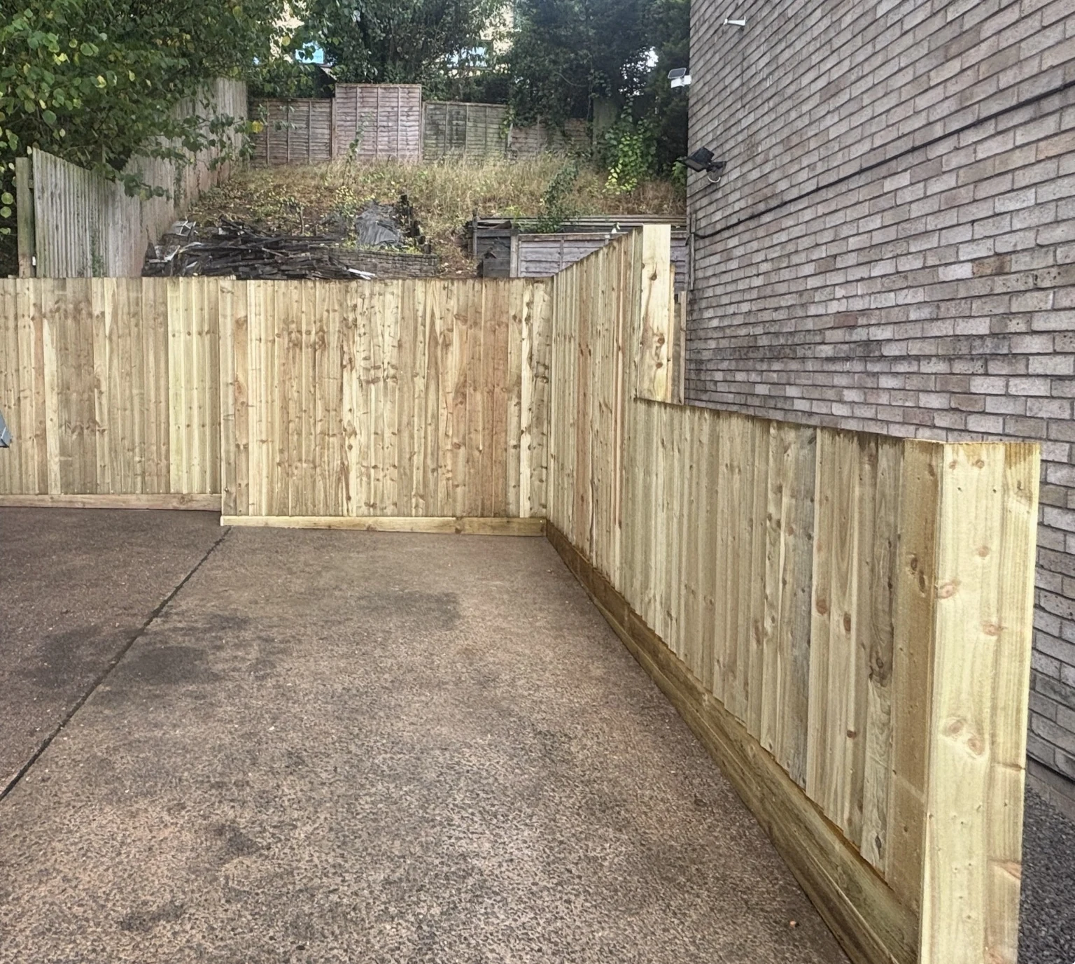 Completed retaining wall, timber fencing and gate rebuild